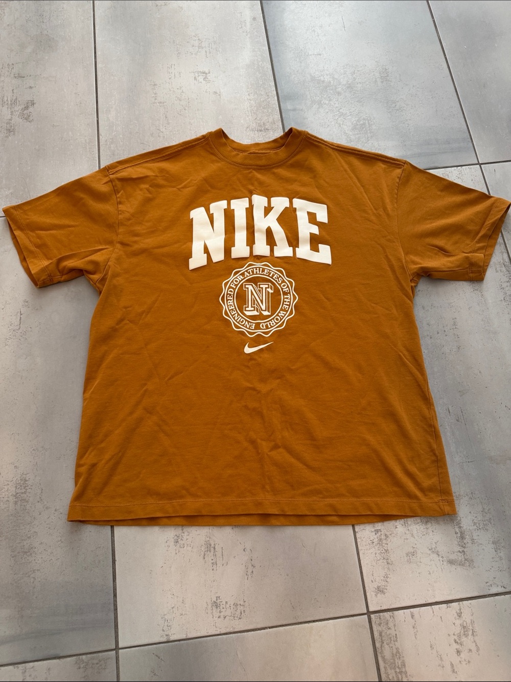 Nike Women’s Sportwear Essentials Short-Sleeve Graphic Tee in Rust Brown